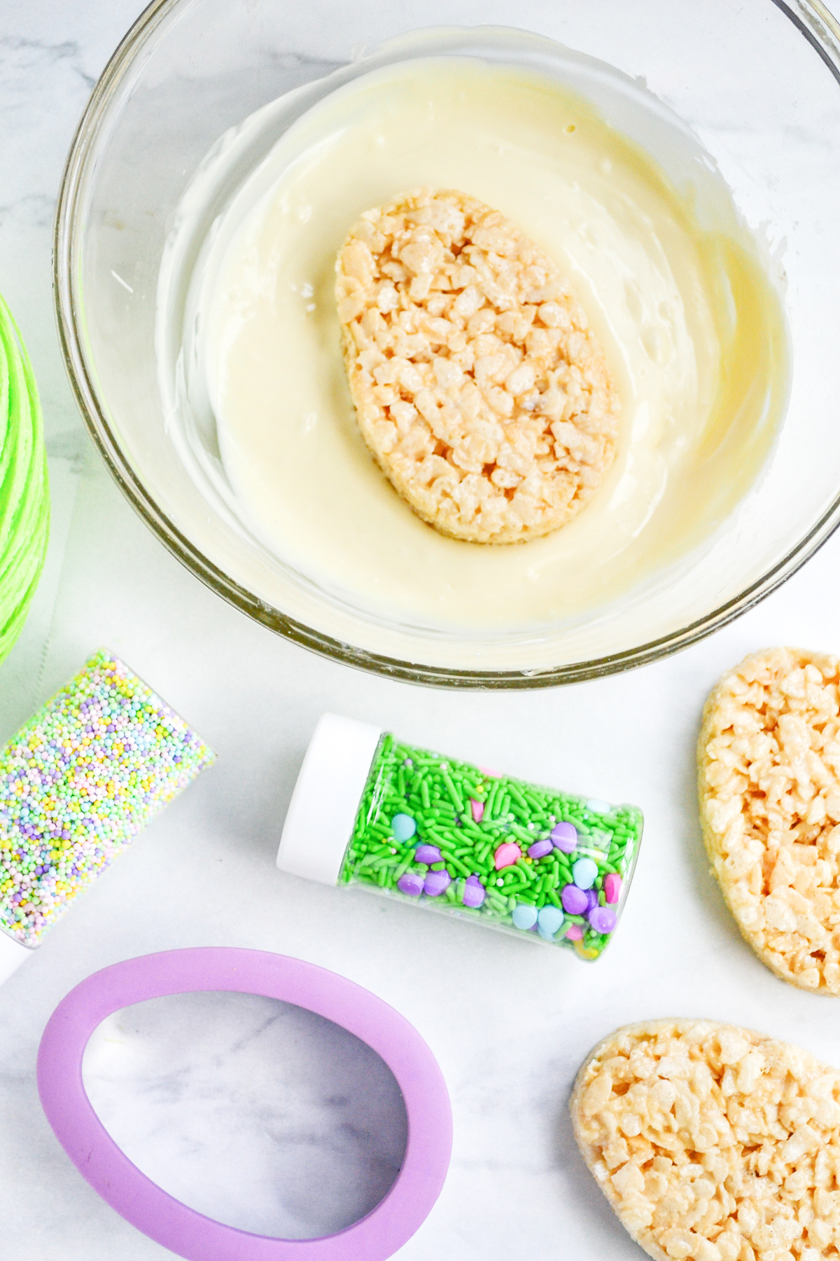 Dip one side of Easter Egg Rice Krispie Treats in white chocolate
