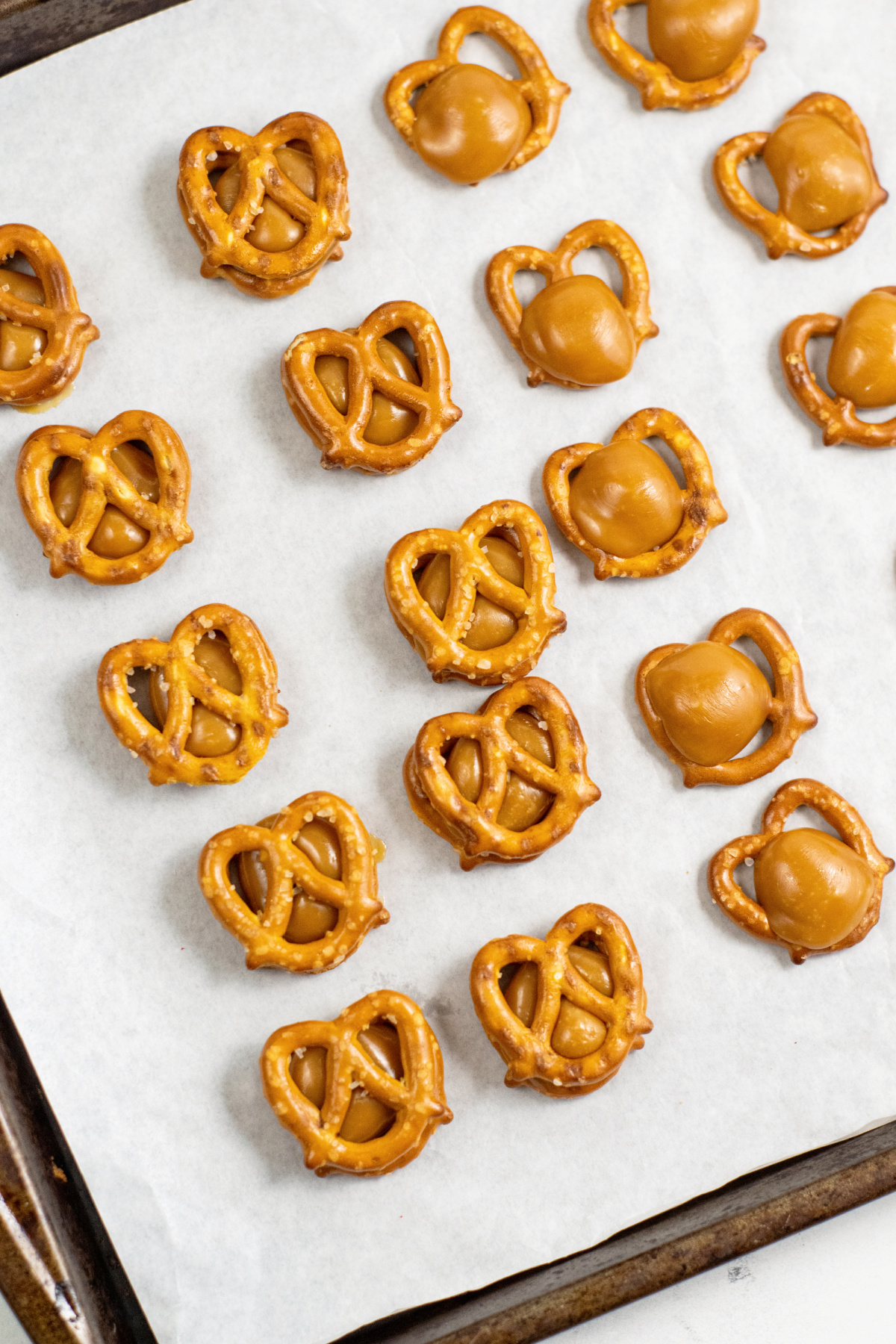 add pretzel on top of softened caramels